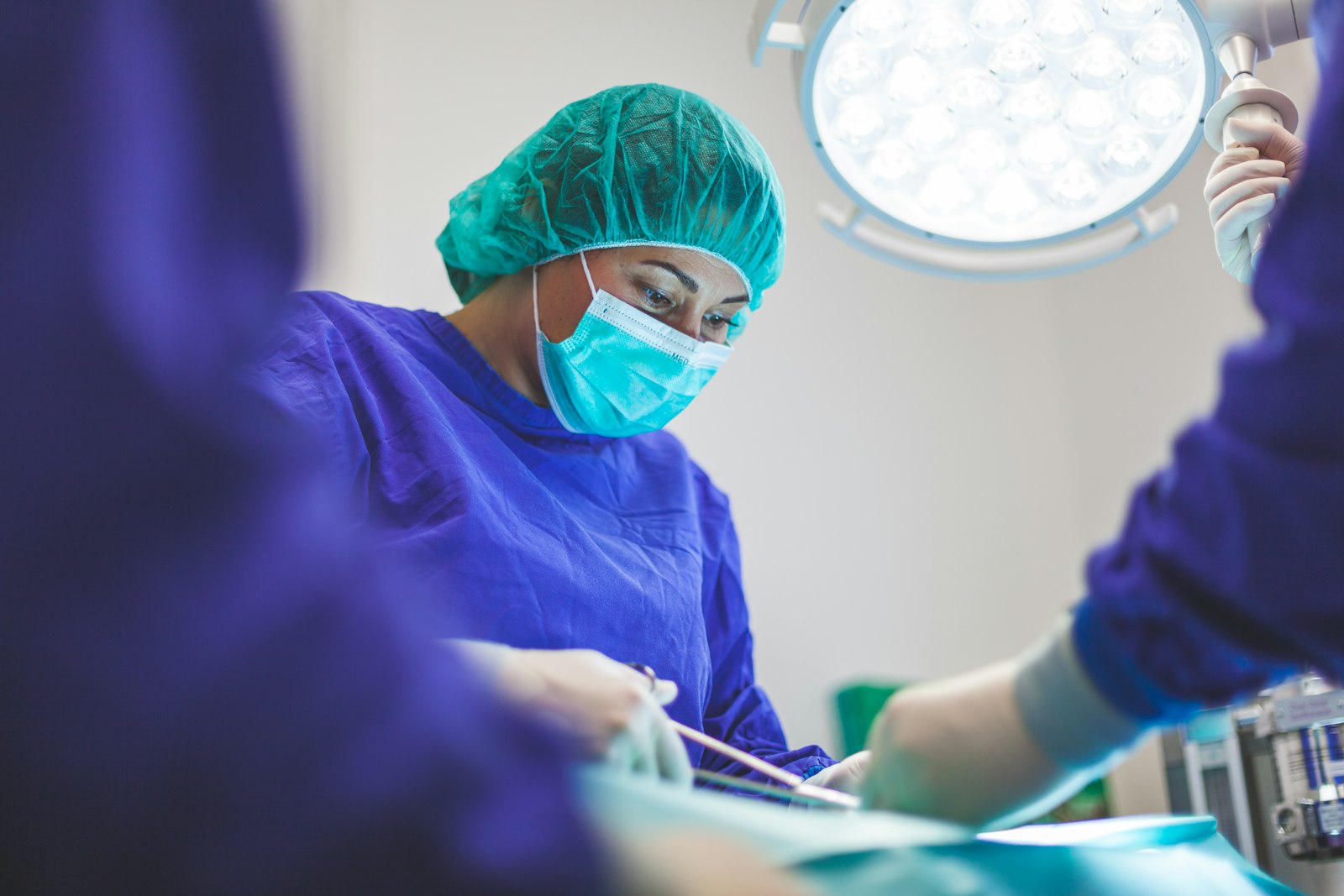 A patient admiring their smile in a hand mirror after treatment