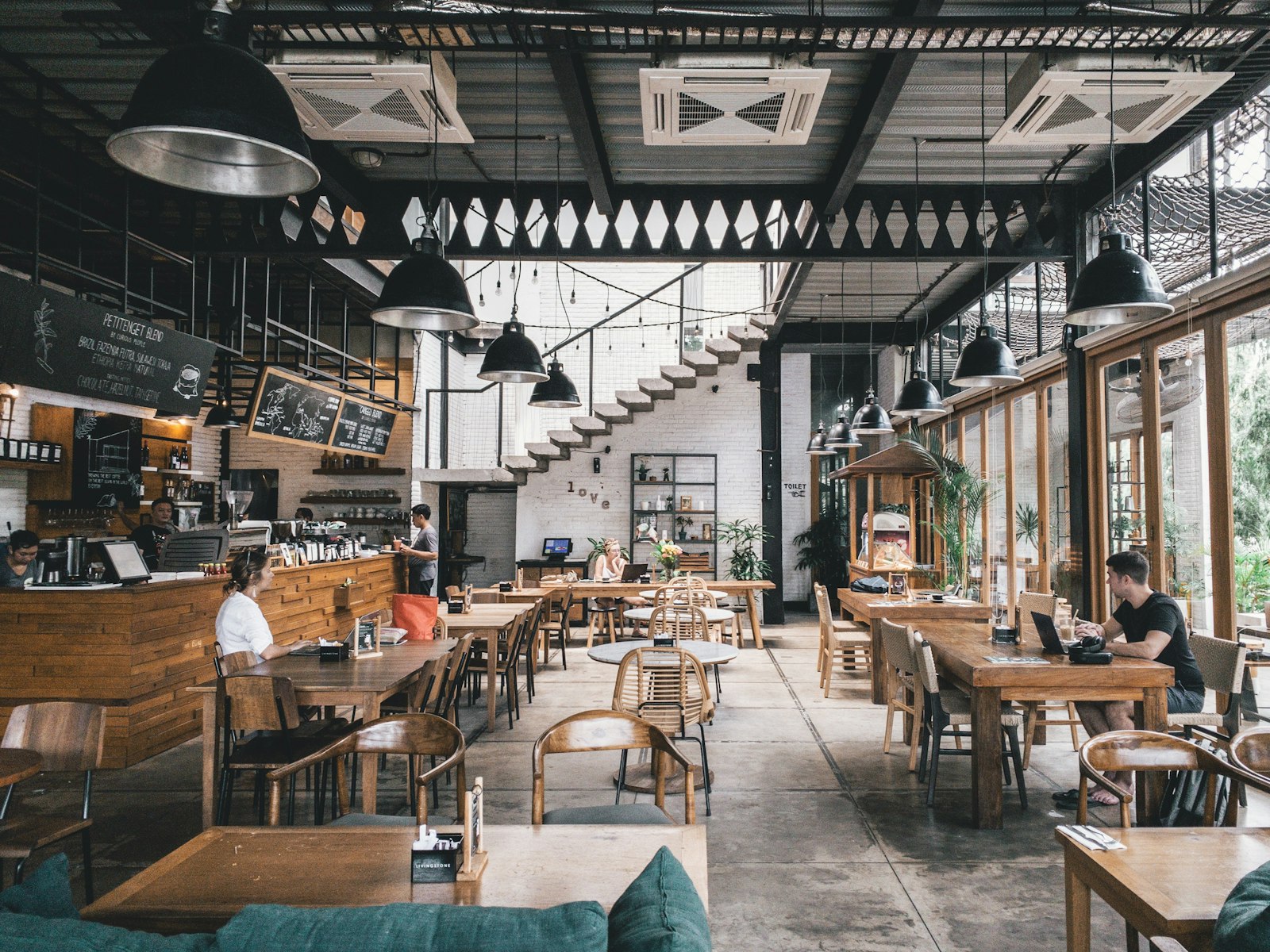 Terracotta-toned interior with linen-draped tables and harbor-facing windows